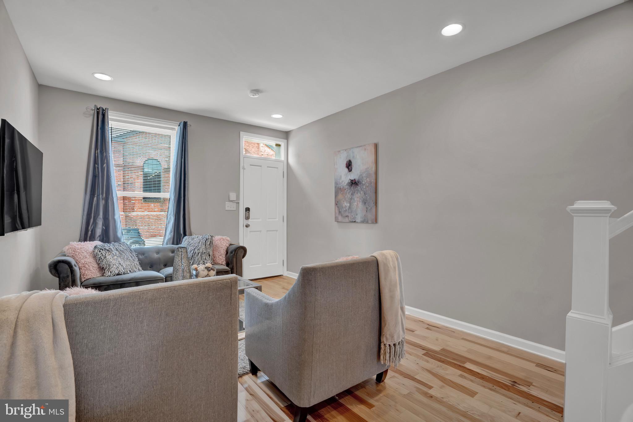 2111 East Chase Street Baltimore, MD 21213 - Photo 4 of 19 a living room with furniture and a window