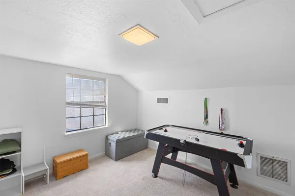 a room with pool table and windows