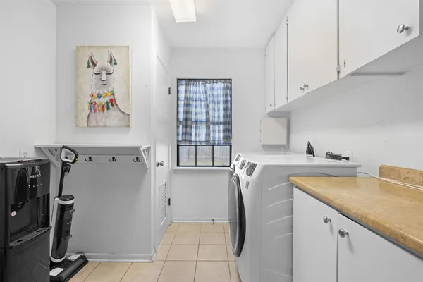 a view of a kitchen with fridge and workspace