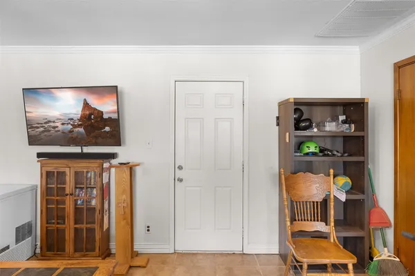 a front view of a house with garden space and furniture