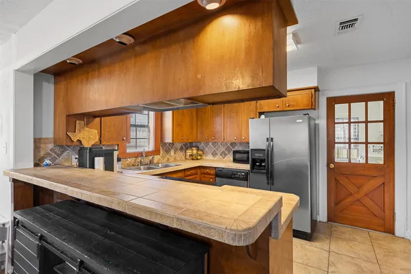 a kitchen with refrigerator and window
