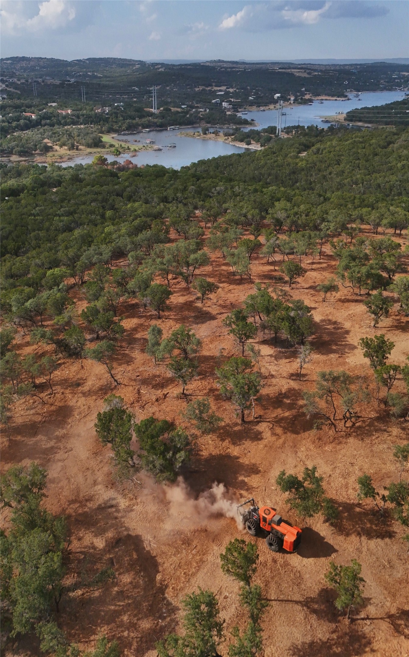 4155 Bee Creek Road Spicewood, TX 78669 - Photo 9 of 21 Sweeping hillsides dotted with native trees overlook sparkling blue water under open skies.