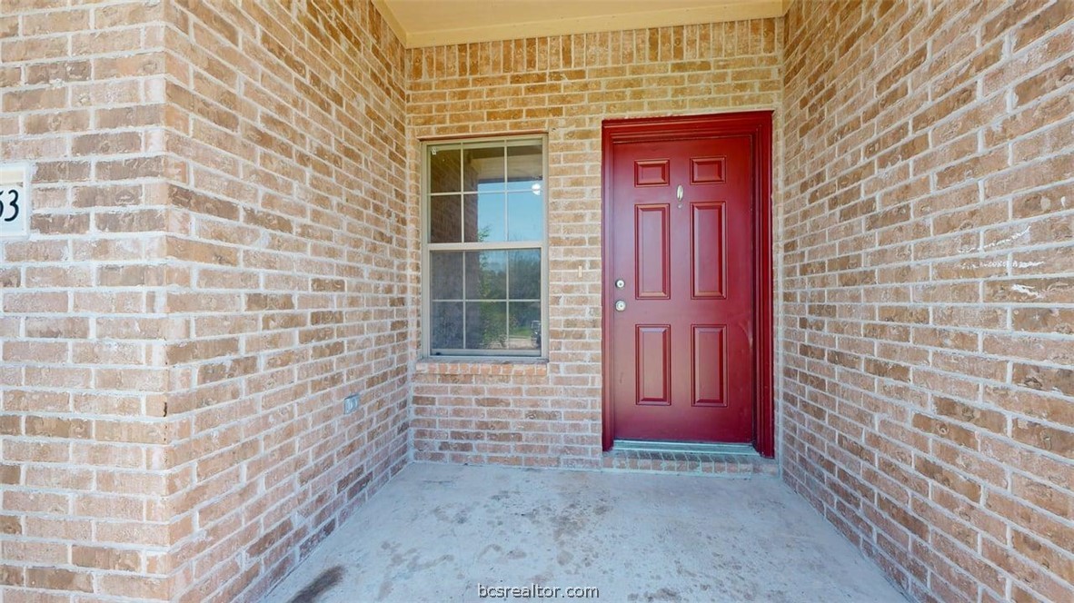 4453-4455 Reveille Road College Station, TX 77845 - Photo 3 of 37 a view of a brick house with a red door and a wooden door