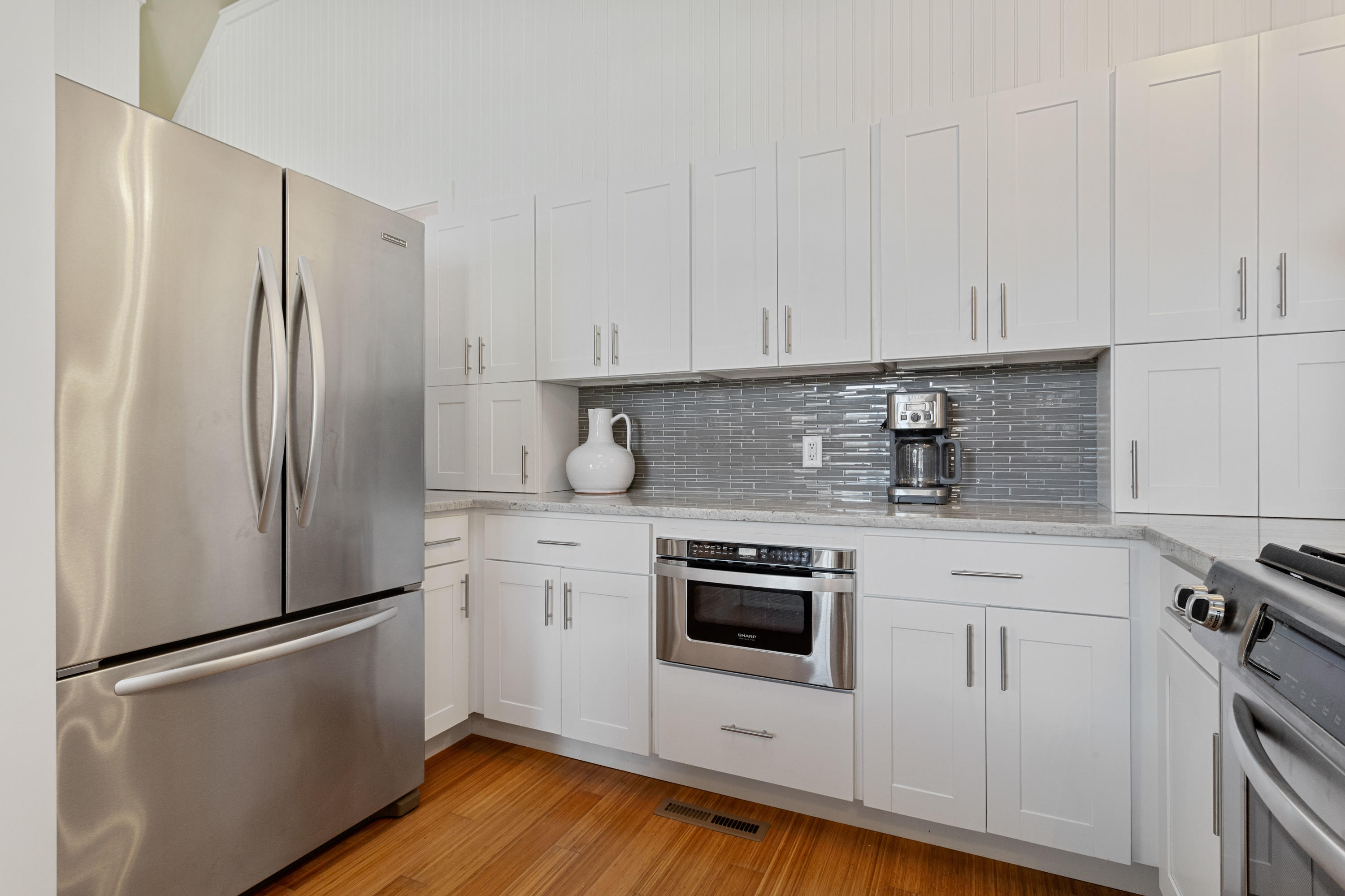 205 Uncle Percy's Road Mashpee, MA 02649 - Photo 16 of 54 a kitchen with stainless steel appliances a refrigerator stove and sink