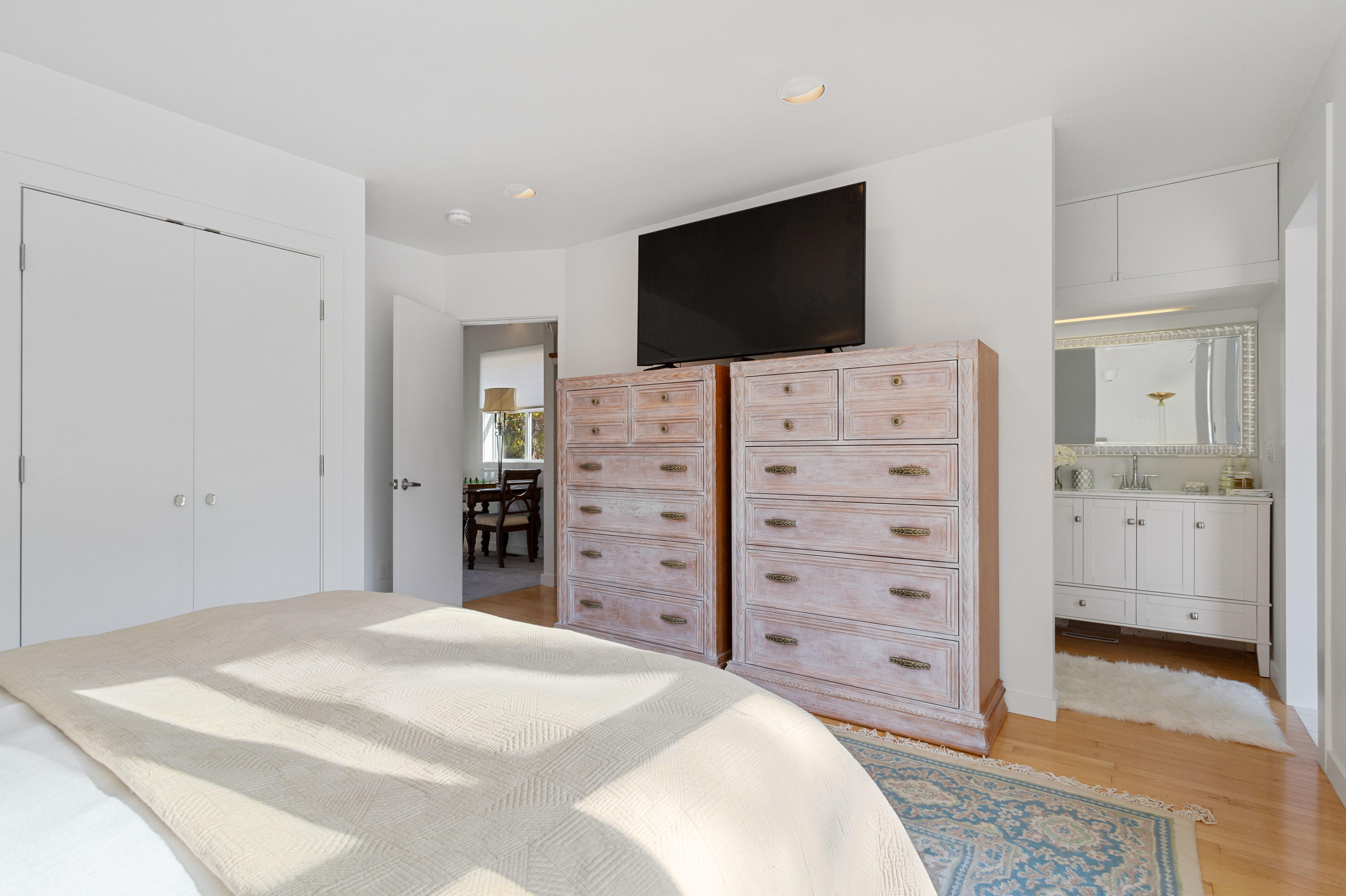 205 Uncle Percy's Road Mashpee, MA 02649 - Photo 40 of 54 a bedroom with a bed and a flat screen tv in white wall