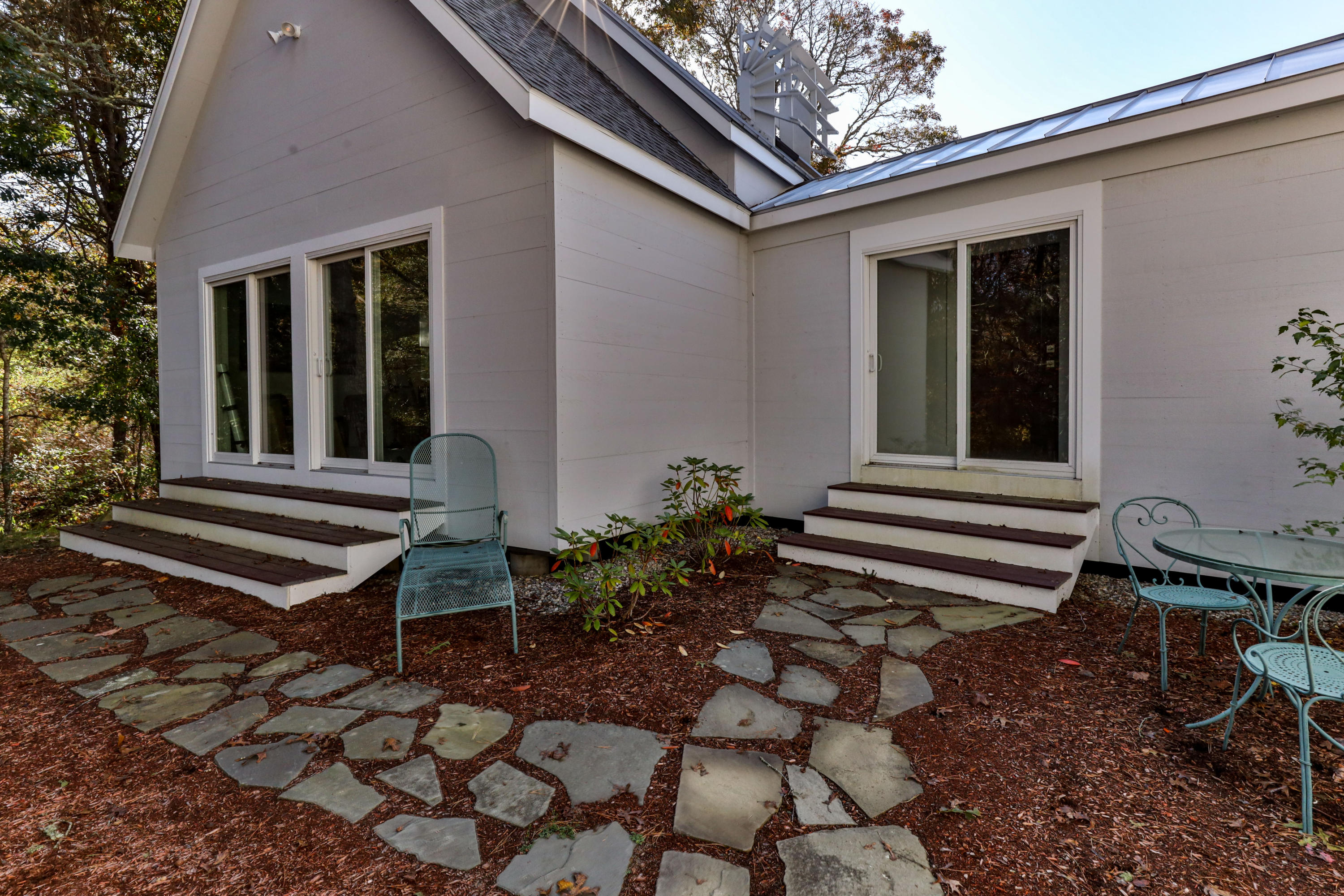 205 Uncle Percy's Road Mashpee, MA 02649 - Photo 51 of 54 a house with a bench in front of it