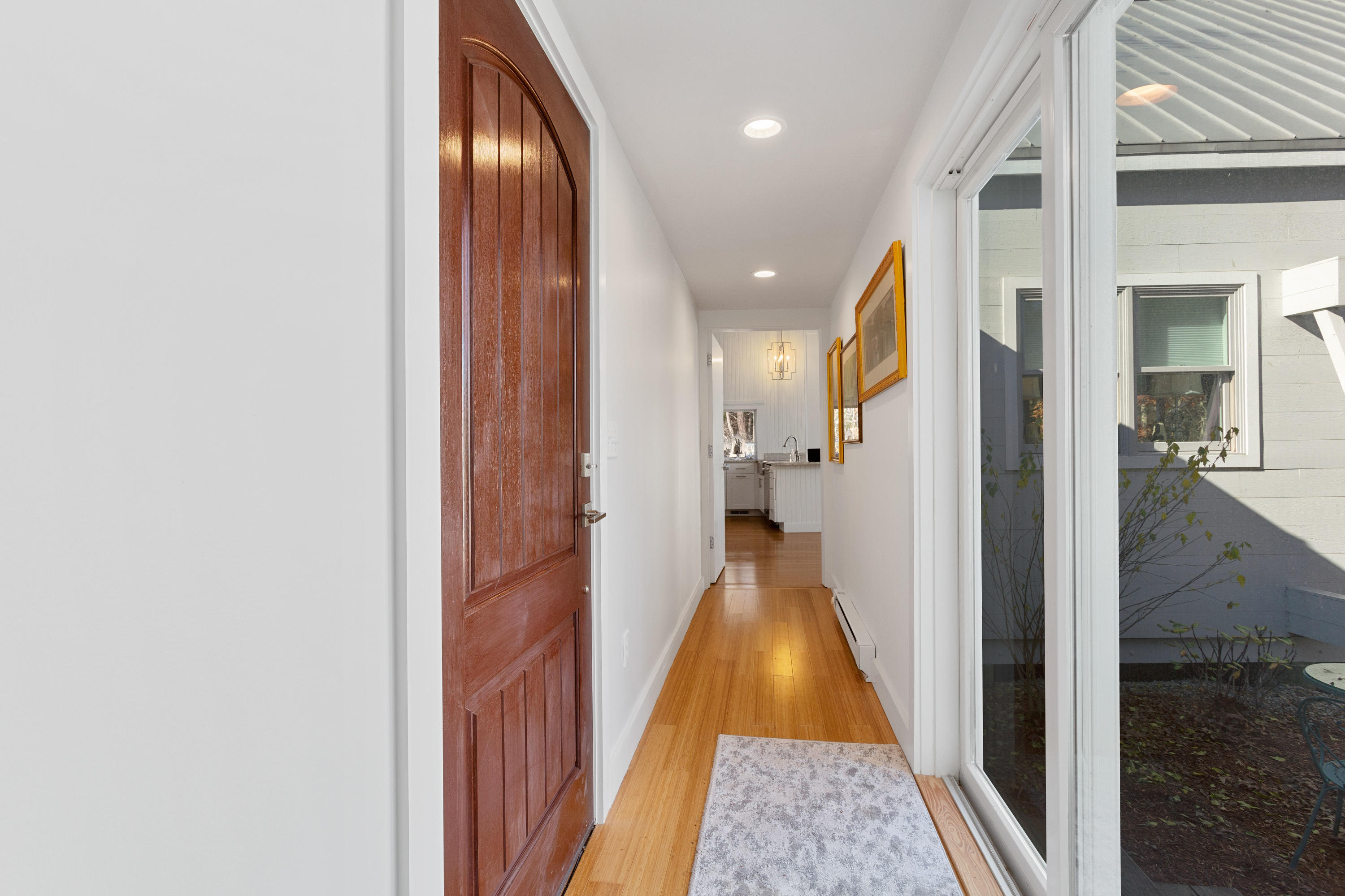 205 Uncle Percy's Road Mashpee, MA 02649 - Photo 9 of 54 a view of a hallway with wooden floor and a bathroom
