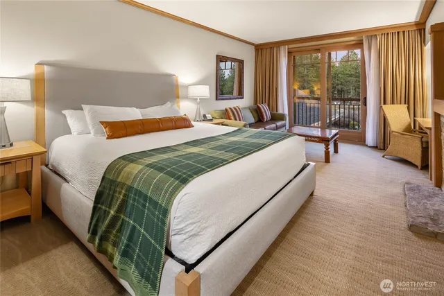 a bedroom with a large bed and a large window