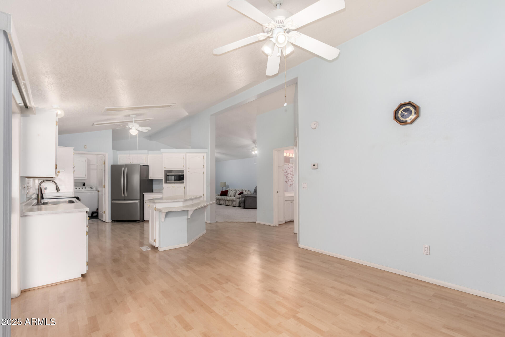 2101 South Meridian Road, Unit 27 Apache Junction, AZ 85120 - Photo 12 of 29 a view of a kitchen with wooden floor and stainless steel appliances