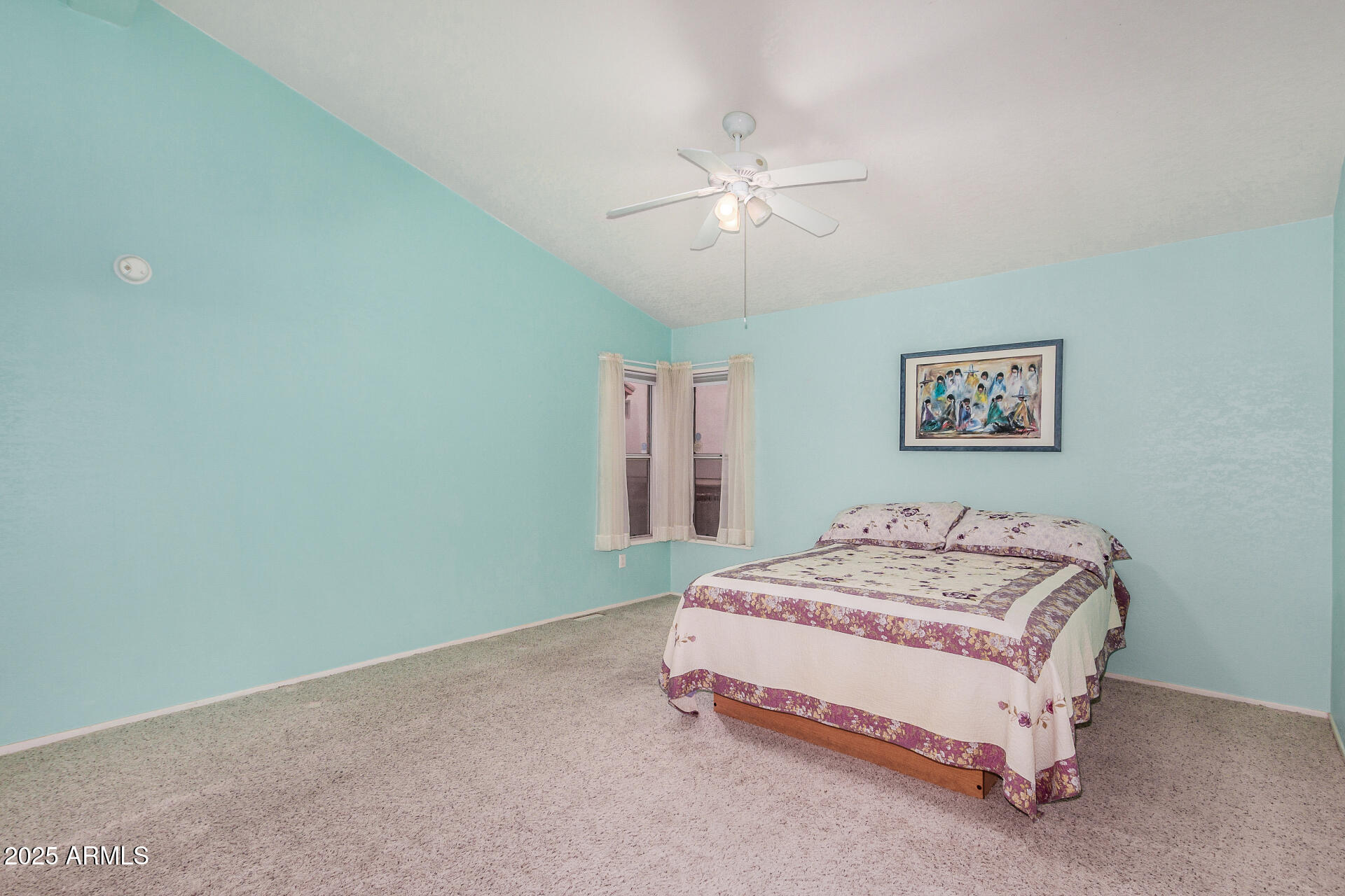 2101 South Meridian Road, Unit 27 Apache Junction, AZ 85120 - Photo 17 of 29 a bedroom with a bed and a chandelier