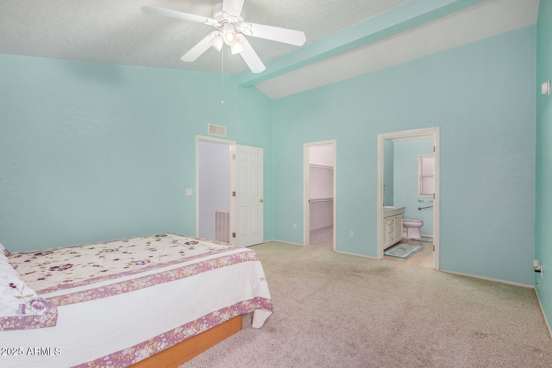 2101 South Meridian Road, Unit 27 Apache Junction, AZ 85120 - Photo 18 of 29 a bedroom with a large bed and a chandelier