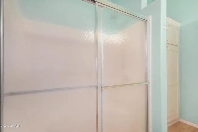 a bathroom with a glass shower door