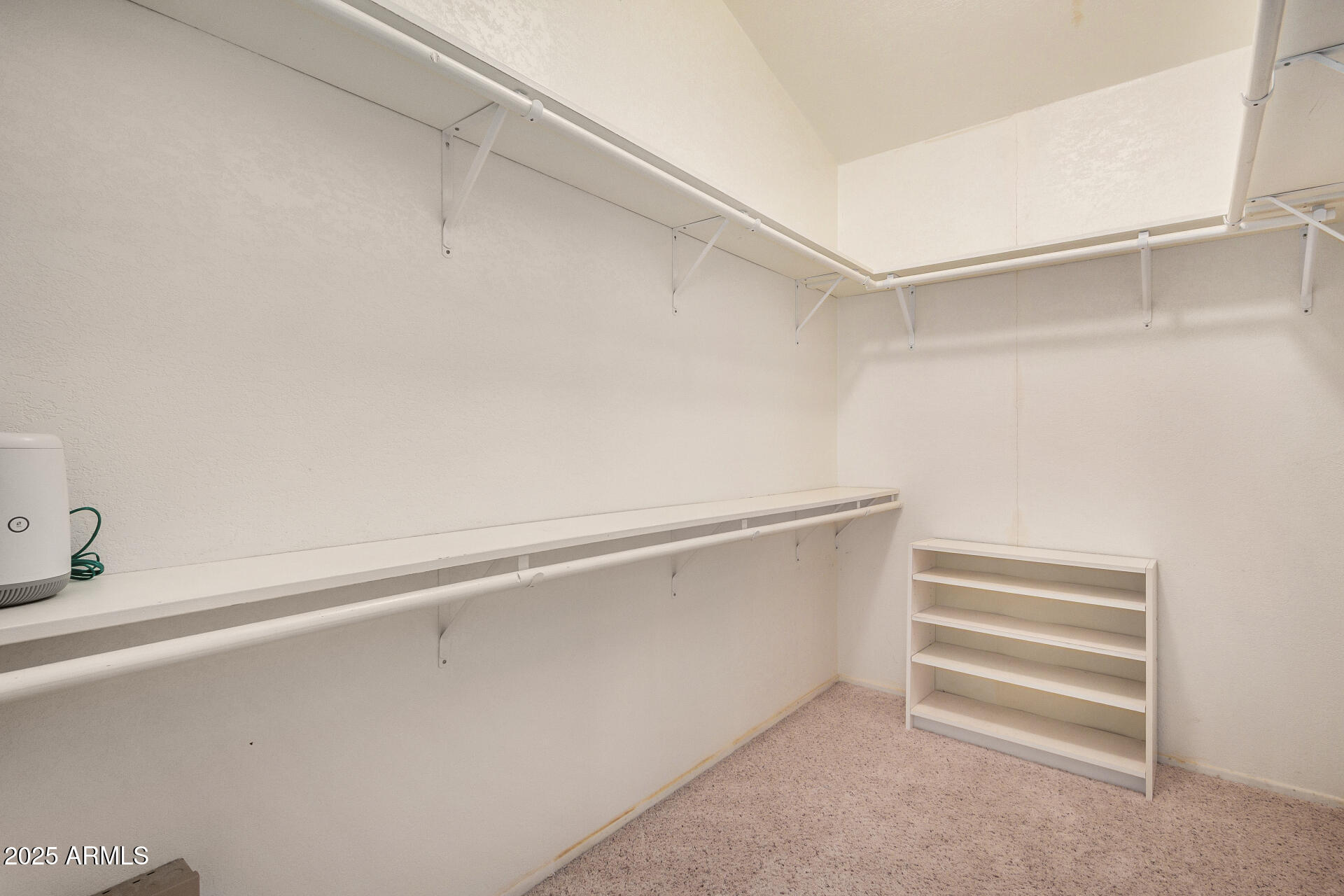 2101 South Meridian Road, Unit 27 Apache Junction, AZ 85120 - Photo 21 of 29 a view of walk in closet with empty racks