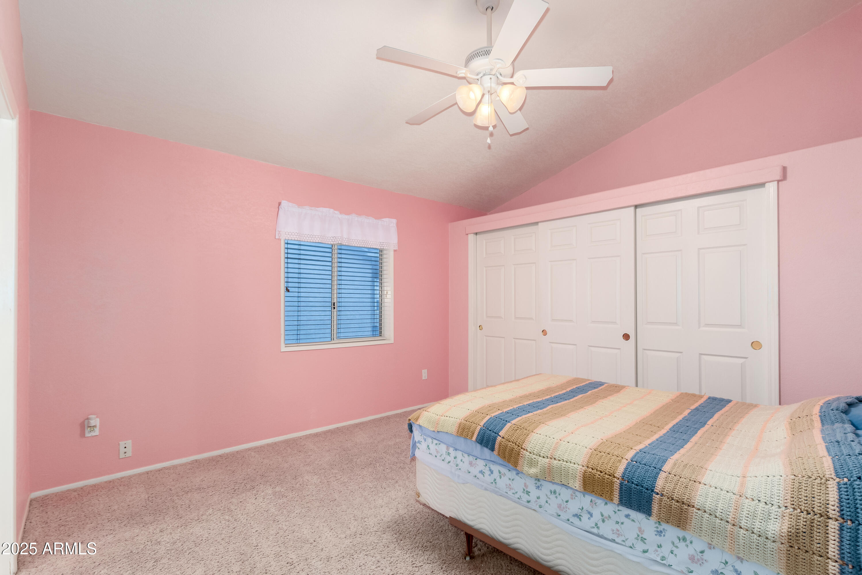 2101 South Meridian Road, Unit 27 Apache Junction, AZ 85120 - Photo 22 of 29 a bedroom with a bed chandelier and a window