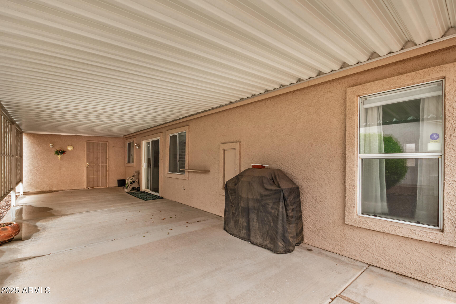 2101 South Meridian Road, Unit 27 Apache Junction, AZ 85120 - Photo 28 of 29 a room with a bed and a large window