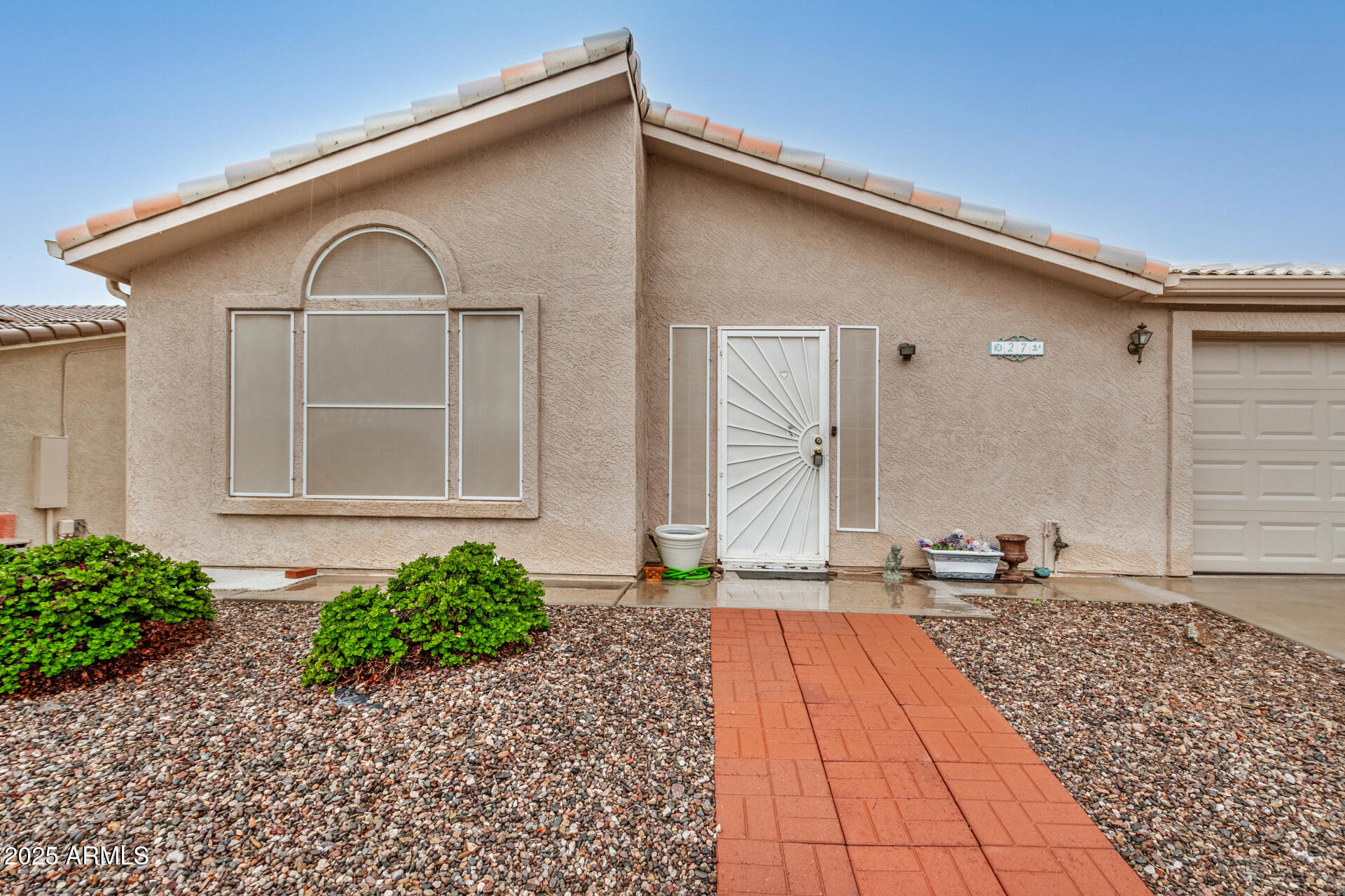 2101 South Meridian Road, Unit 27 Apache Junction, AZ 85120 - Photo 7 of 29 a front view of a house with a yard