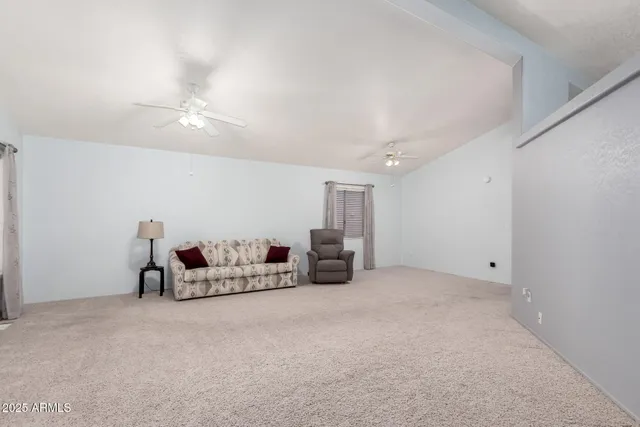 a living room with furniture and a gym machine