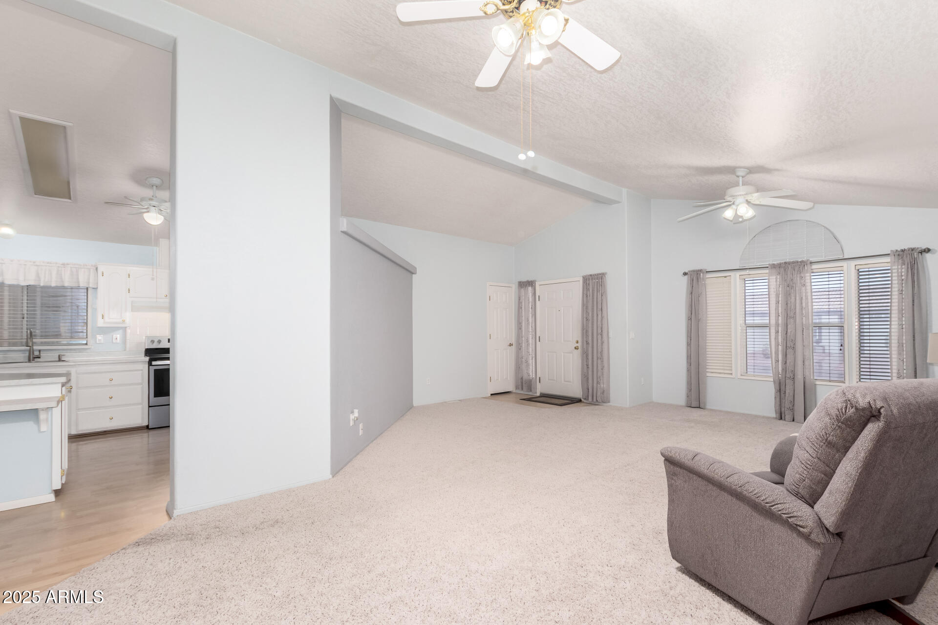 2101 South Meridian Road, Unit 27 Apache Junction, AZ 85120 - Photo 10 of 29 a living room with furniture and a chandelier