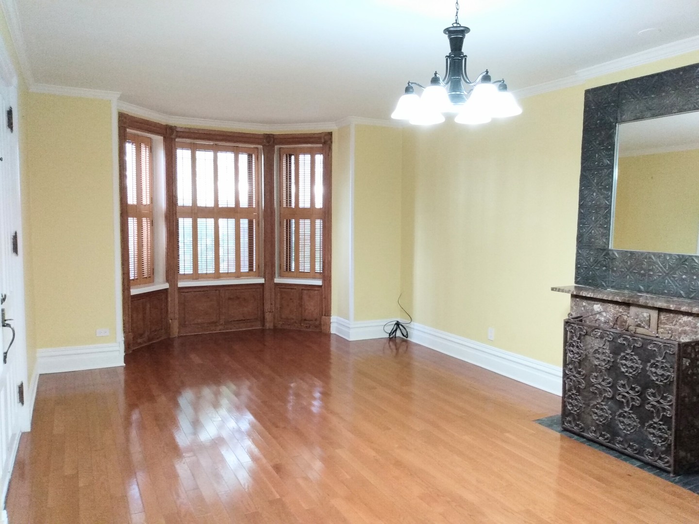 1526 North LaSalle Drive, Unit 1E Chicago, IL 60610 - Photo 11 of 17 a view of an empty room with window and wooden floor