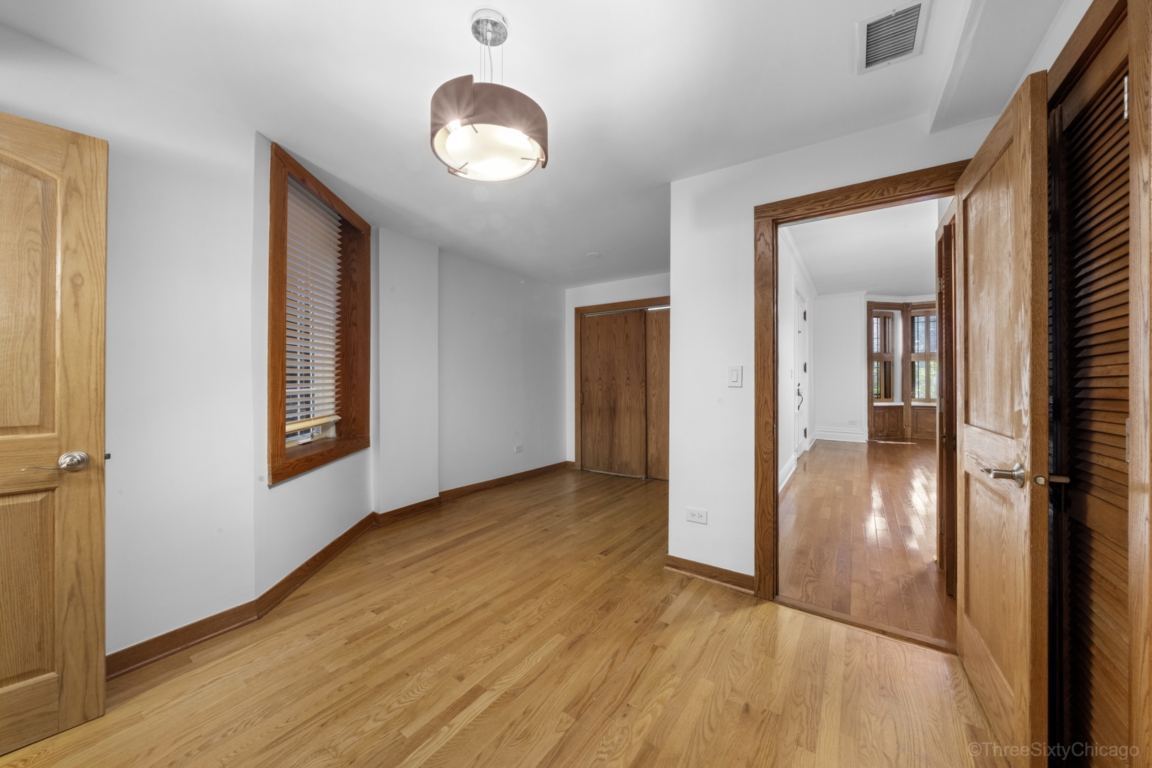 1526 North LaSalle Drive, Unit 1E Chicago, IL 60610 - Photo 13 of 17 wooden floor in a hall with an entryway and a window