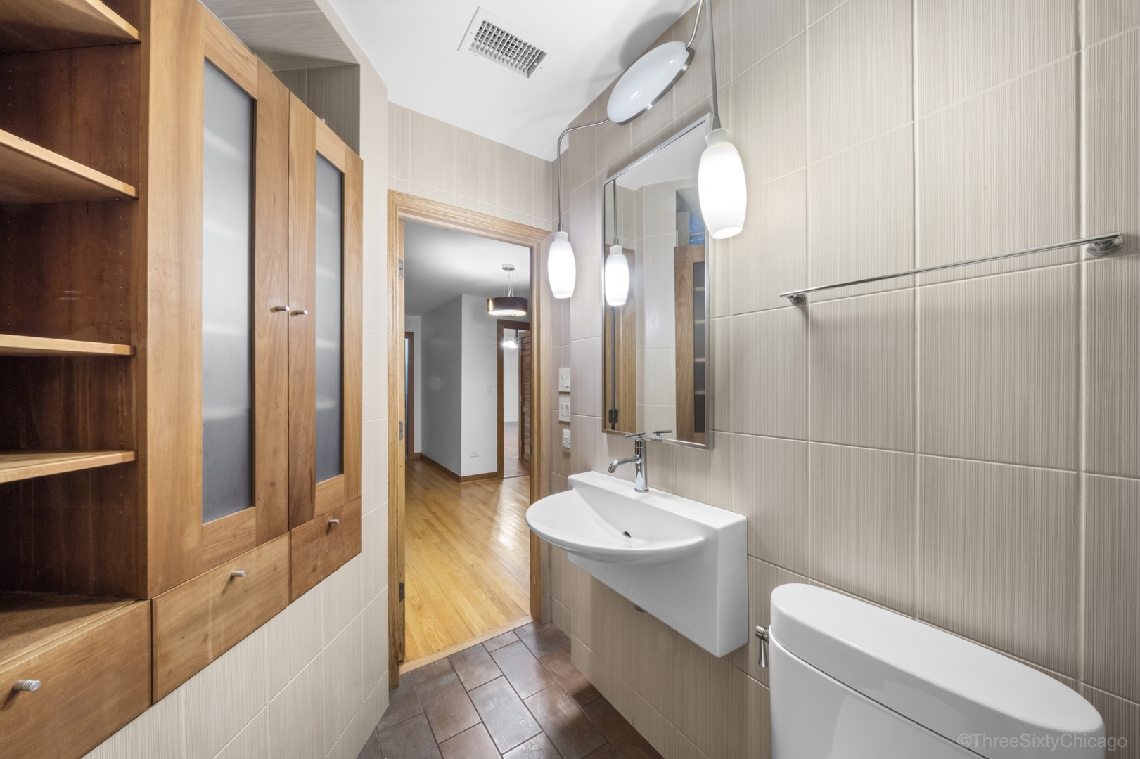 1526 North LaSalle Drive, Unit 1E Chicago, IL 60610 - Photo 15 of 17 a bathroom with a sink a toilet and shower