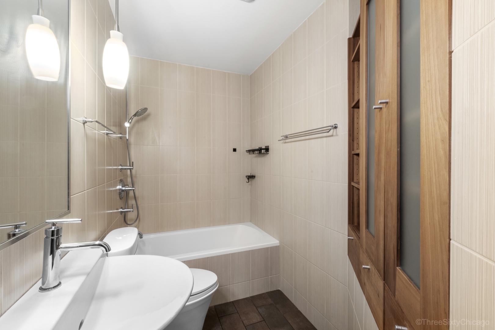 1526 North LaSalle Drive, Unit 1E Chicago, IL 60610 - Photo 16 of 17 a bathroom with a sink a toilet and shower