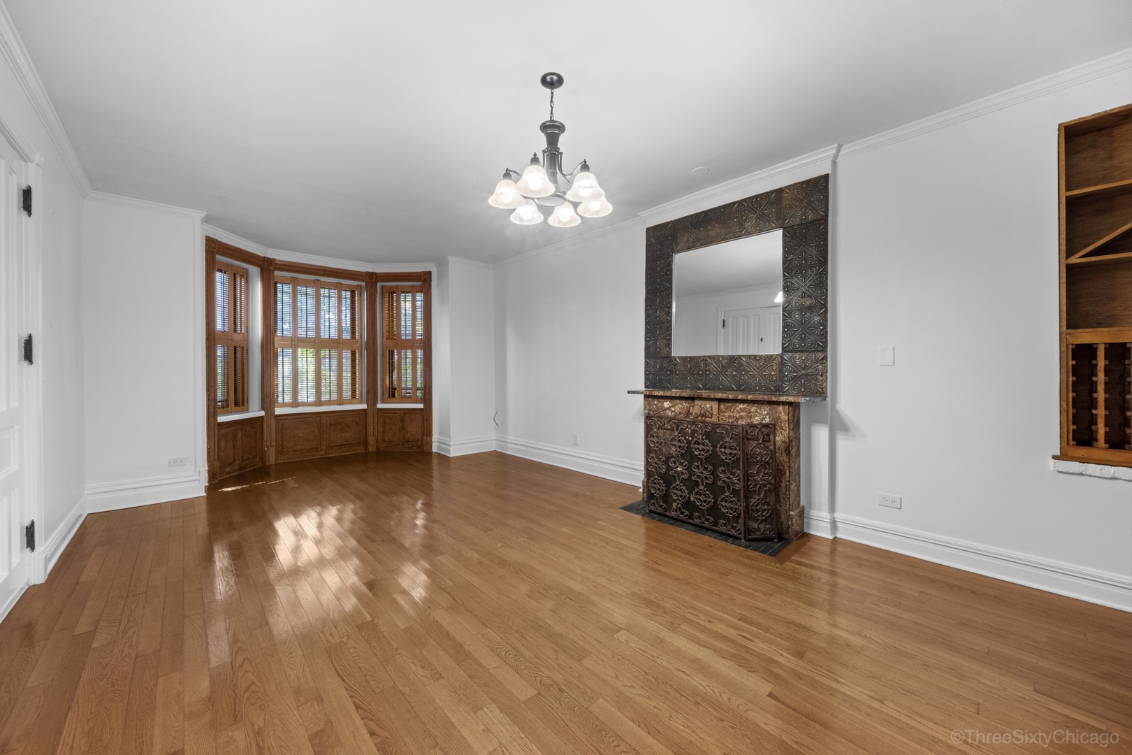 1526 North LaSalle Drive, Unit 1E Chicago, IL 60610 - Photo 5 of 17 a view of an empty room with wooden floor and a window
