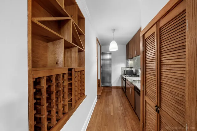 a view of hallway with wooden floor and staircase