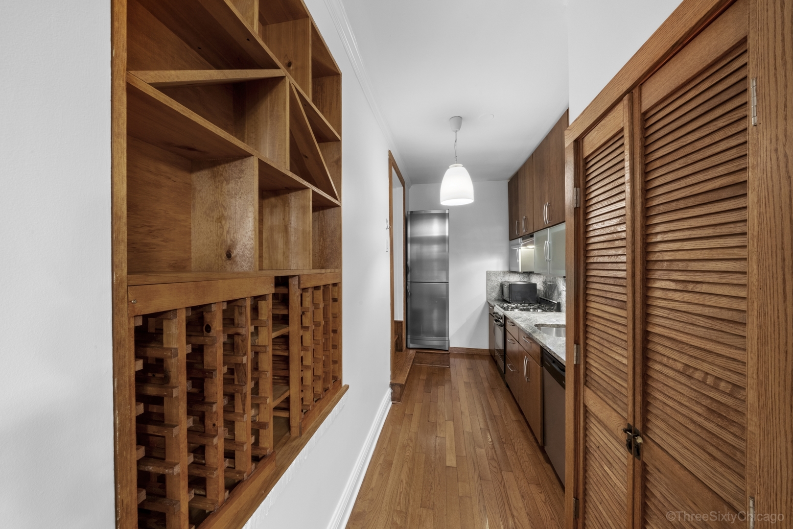 1526 North LaSalle Drive, Unit 1E Chicago, IL 60610 - Photo 9 of 17 a view of hallway with wooden floor and staircase