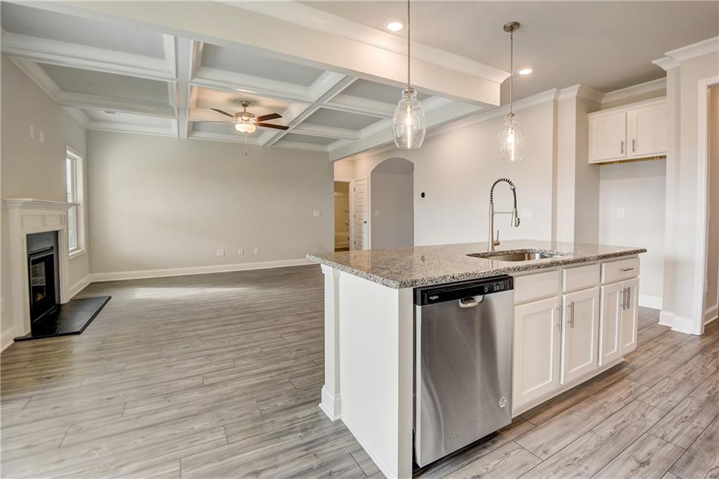255 Wingate Drive Winder, GA 30680 - Photo 13 of 76 a kitchen with a sink cabinets stainless steel appliances and wooden floor