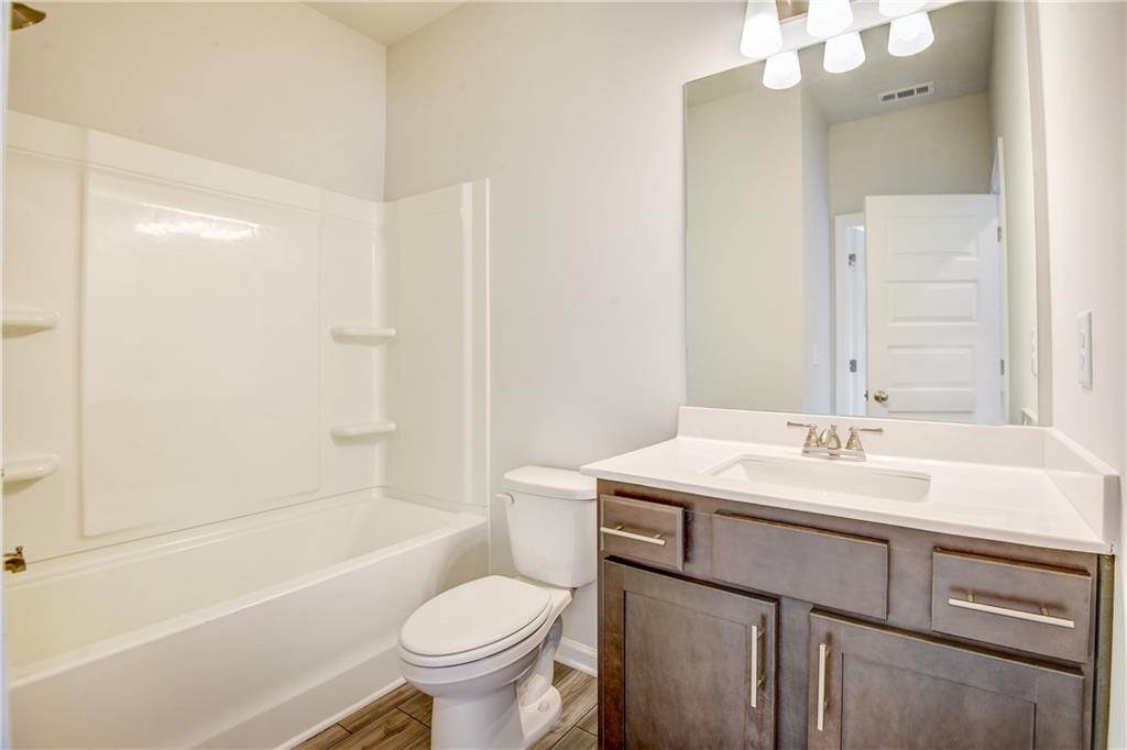 255 Wingate Drive Winder, GA 30680 - Photo 16 of 76 a bathroom with a sink toilet vanity and tub