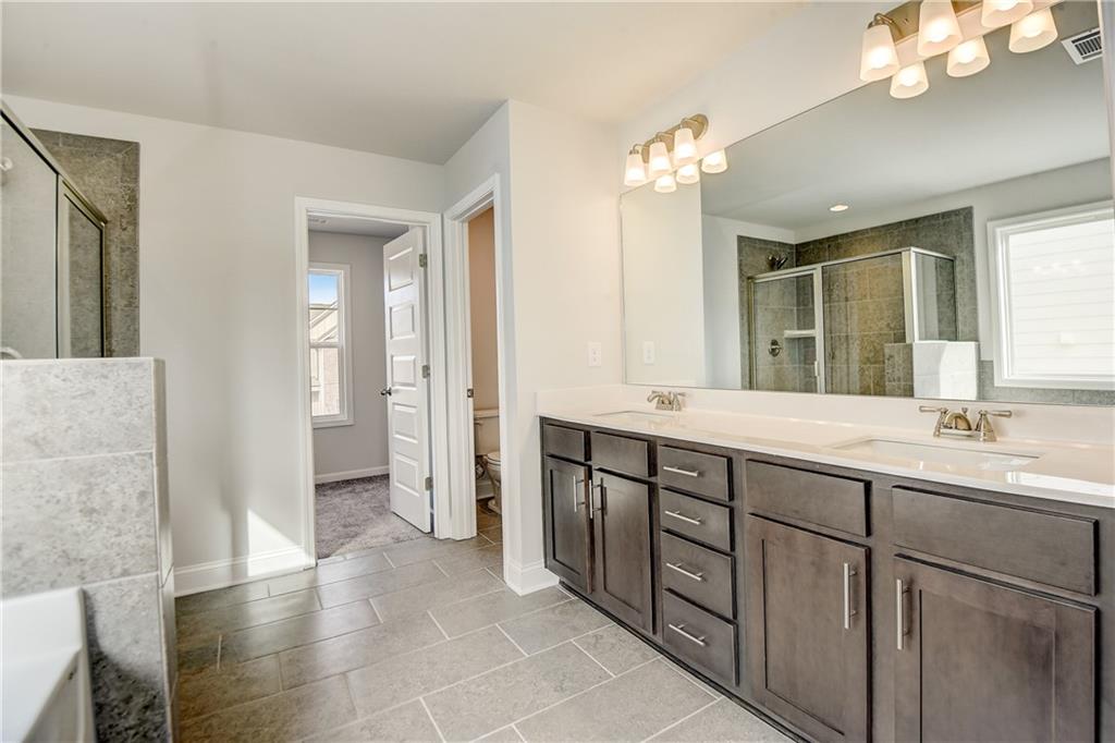 255 Wingate Drive Winder, GA 30680 - Photo 22 of 76 a bathroom with a double vanity sink and a mirror