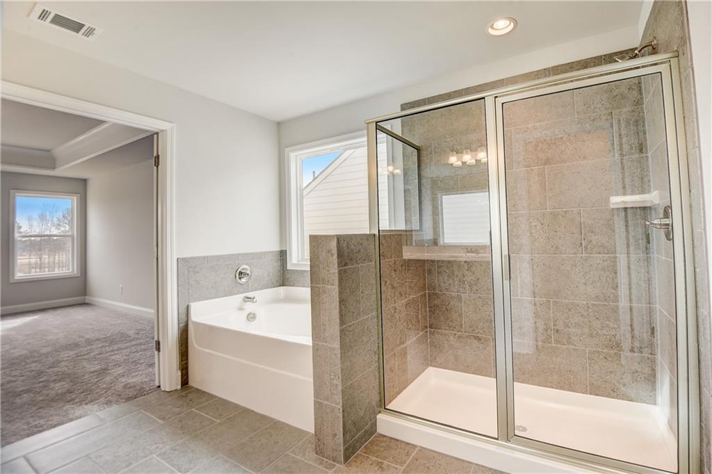 255 Wingate Drive Winder, GA 30680 - Photo 24 of 76 a bathroom with a bathtub and a shower