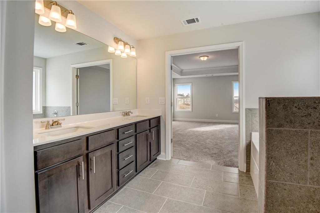 255 Wingate Drive Winder, GA 30680 - Photo 25 of 76 a spacious bathroom with a double vanity sink mirror and shower