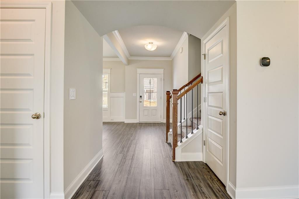 255 Wingate Drive Winder, GA 30680 - Photo 8 of 76 a view of a hallway with wooden floor and staircase