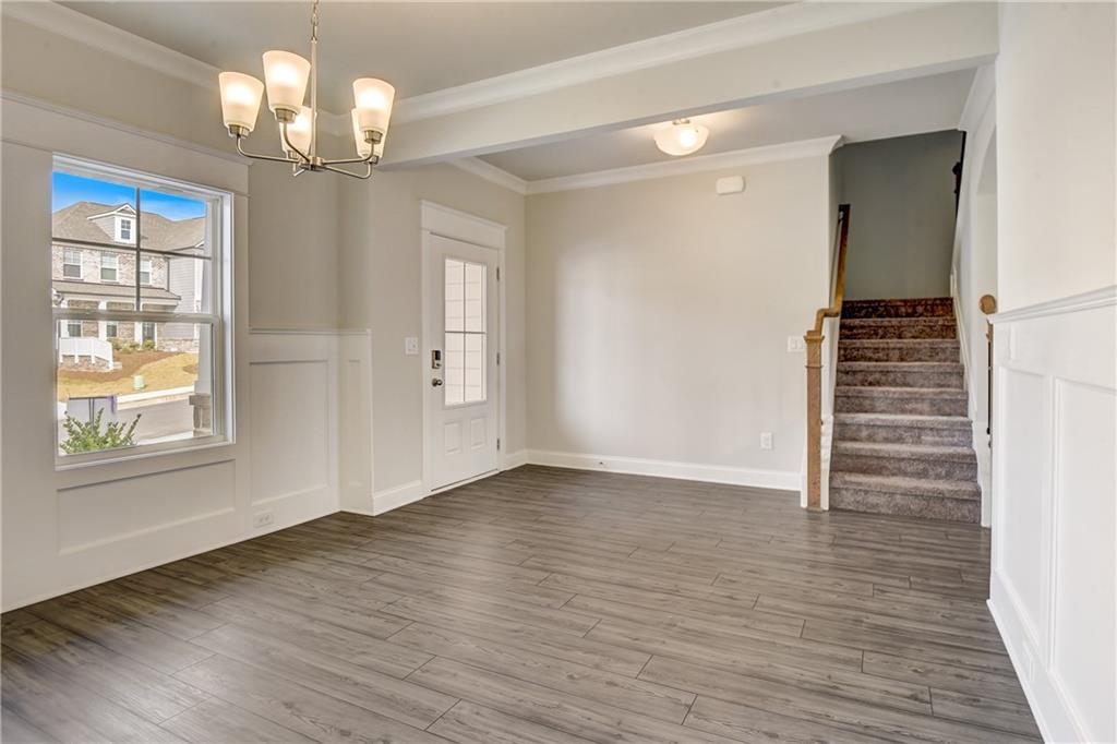 255 Wingate Drive Winder, GA 30680 - Photo 9 of 76 a view of empty room with wooden floor and fan