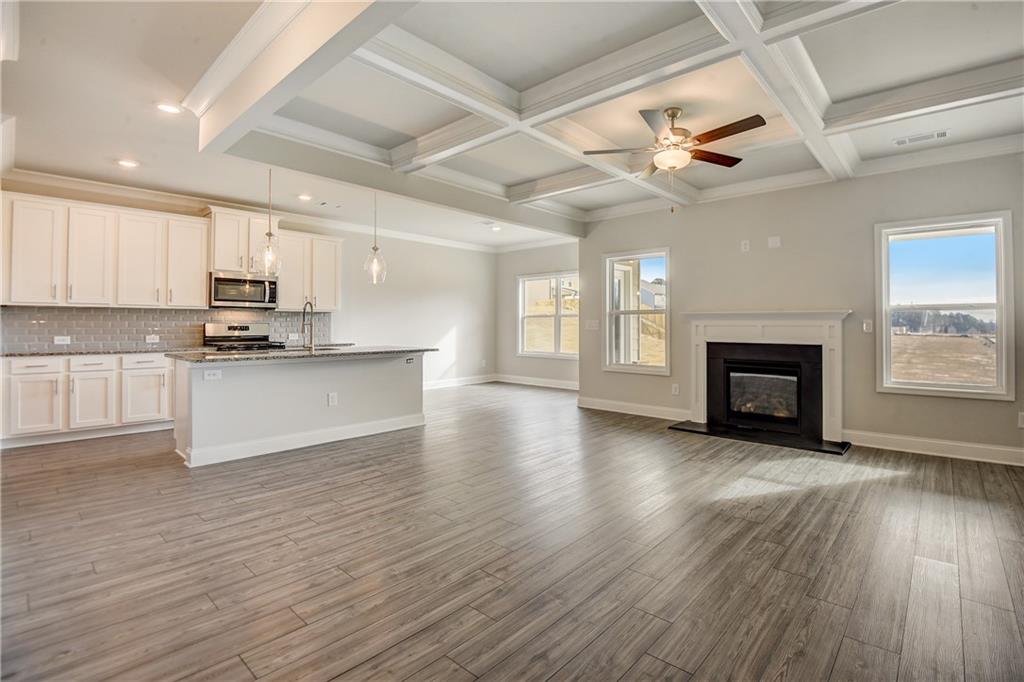 255 Wingate Drive Winder, GA 30680 - Photo 10 of 76 a kitchen with stainless steel appliances granite countertop a stove top oven a sink and a white cabinets