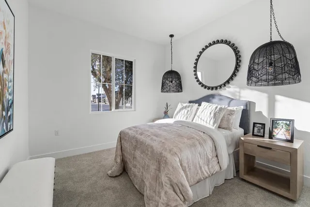 a bathroom with a granite countertop sink toilet a large mirror a shower and vanity