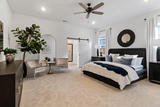 a bathroom with a tub a double vanity sink and a mirror