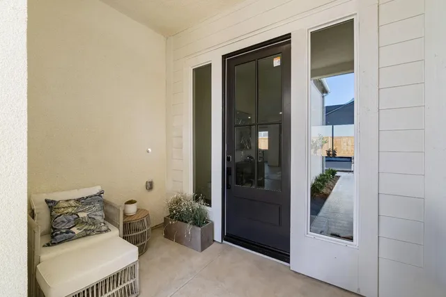 a bedroom with a bed and a potted plant in front of door