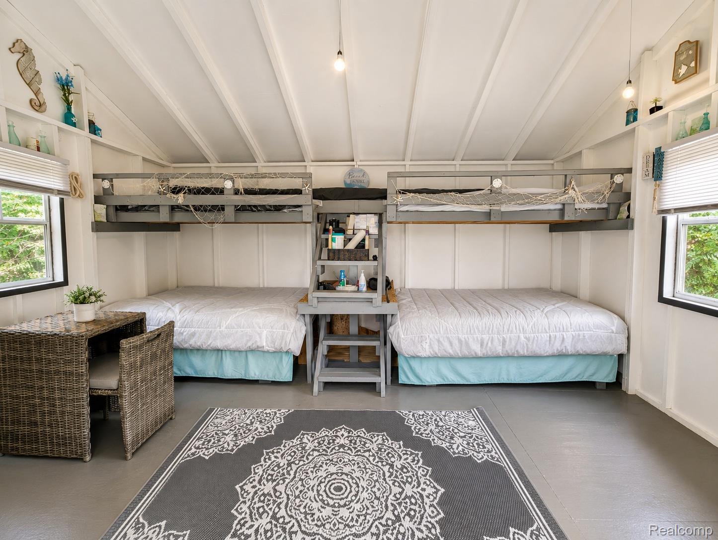643 North Hockaday Road Gladwin, MI 48624 - Photo 16 of 24 Vaulted ceiling room featuring two elevated bunk beds and two platform beds