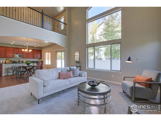 a kitchen with stainless steel appliances kitchen island granite countertop a dining table chairs and granite counter tops