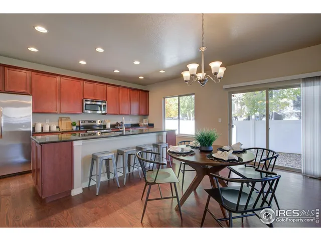 a view of a dining room with furniture and chandelier