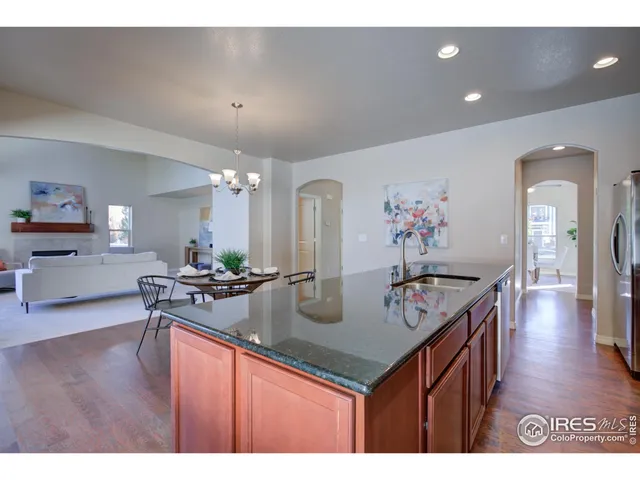 a kitchen with granite countertop stainless steel appliances sink and cabinets