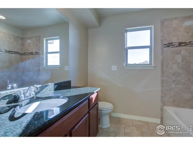 a bathroom with a shower and a wooden floor