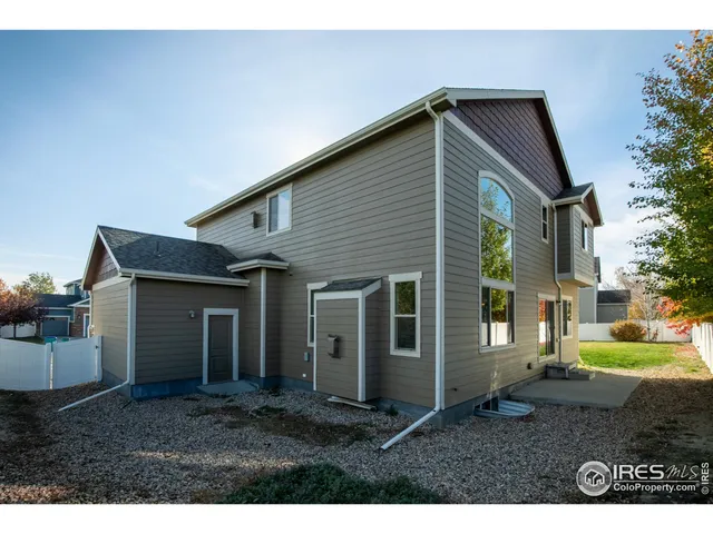 a backyard of a house with plants and trees