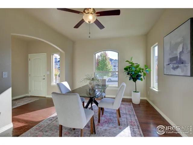 a view of a dining room with furniture and a potted plant