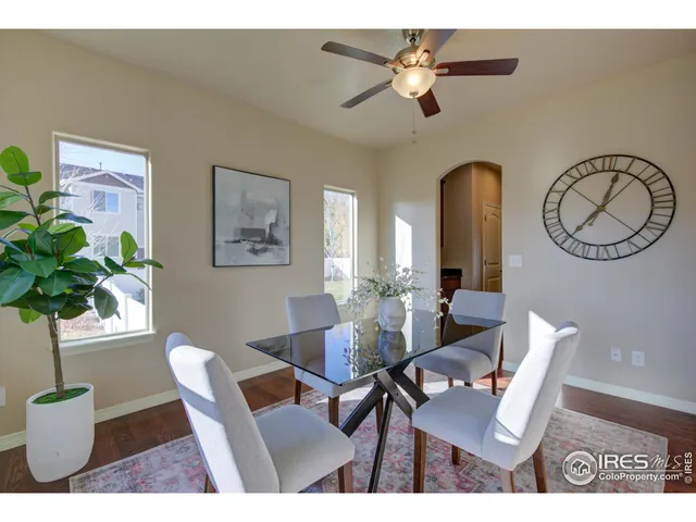 a living room with furniture a large window and a fireplace