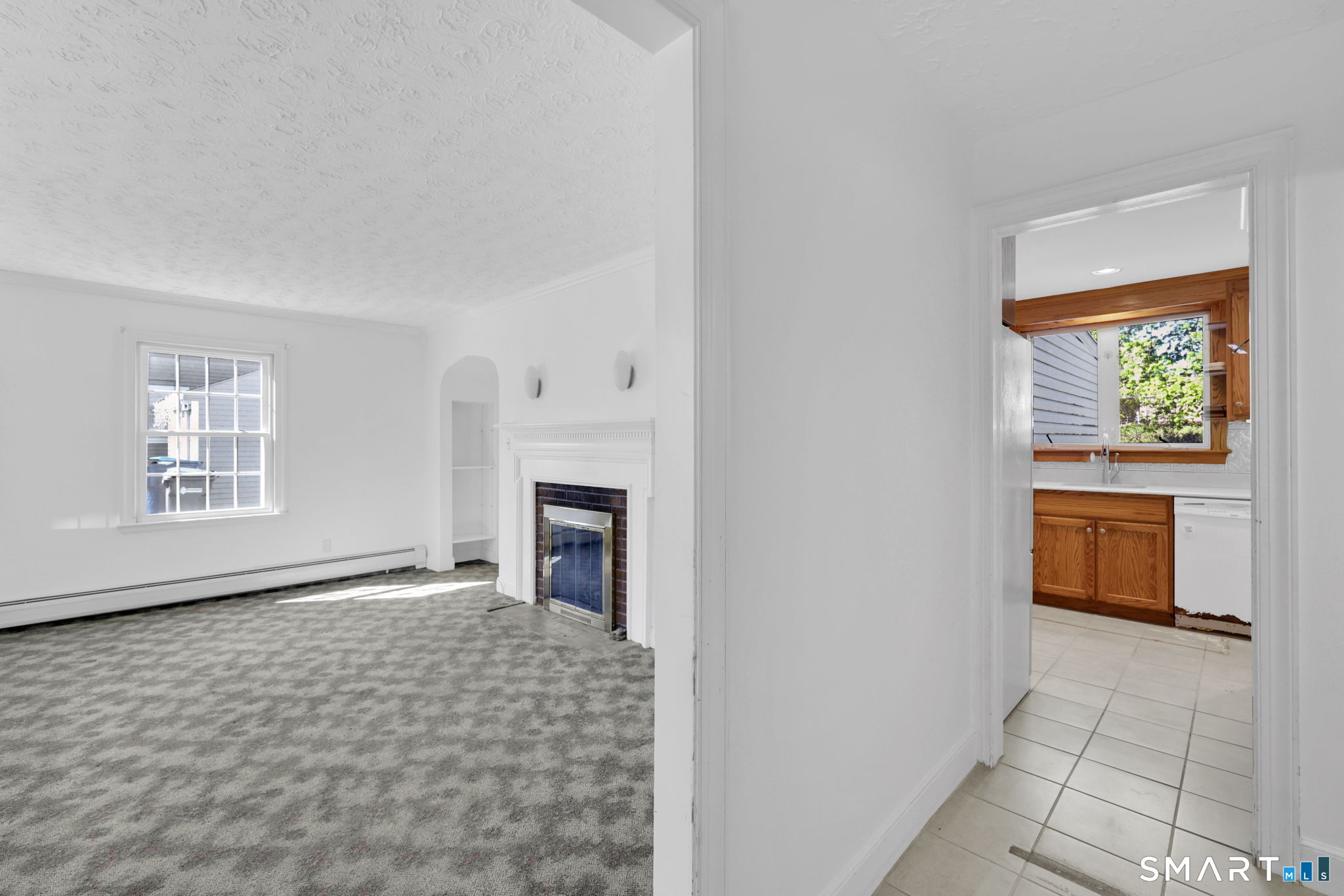 53 Alexander Street Manchester, CT 06040 - Photo 11 of 35 a big room with windows and a fireplace