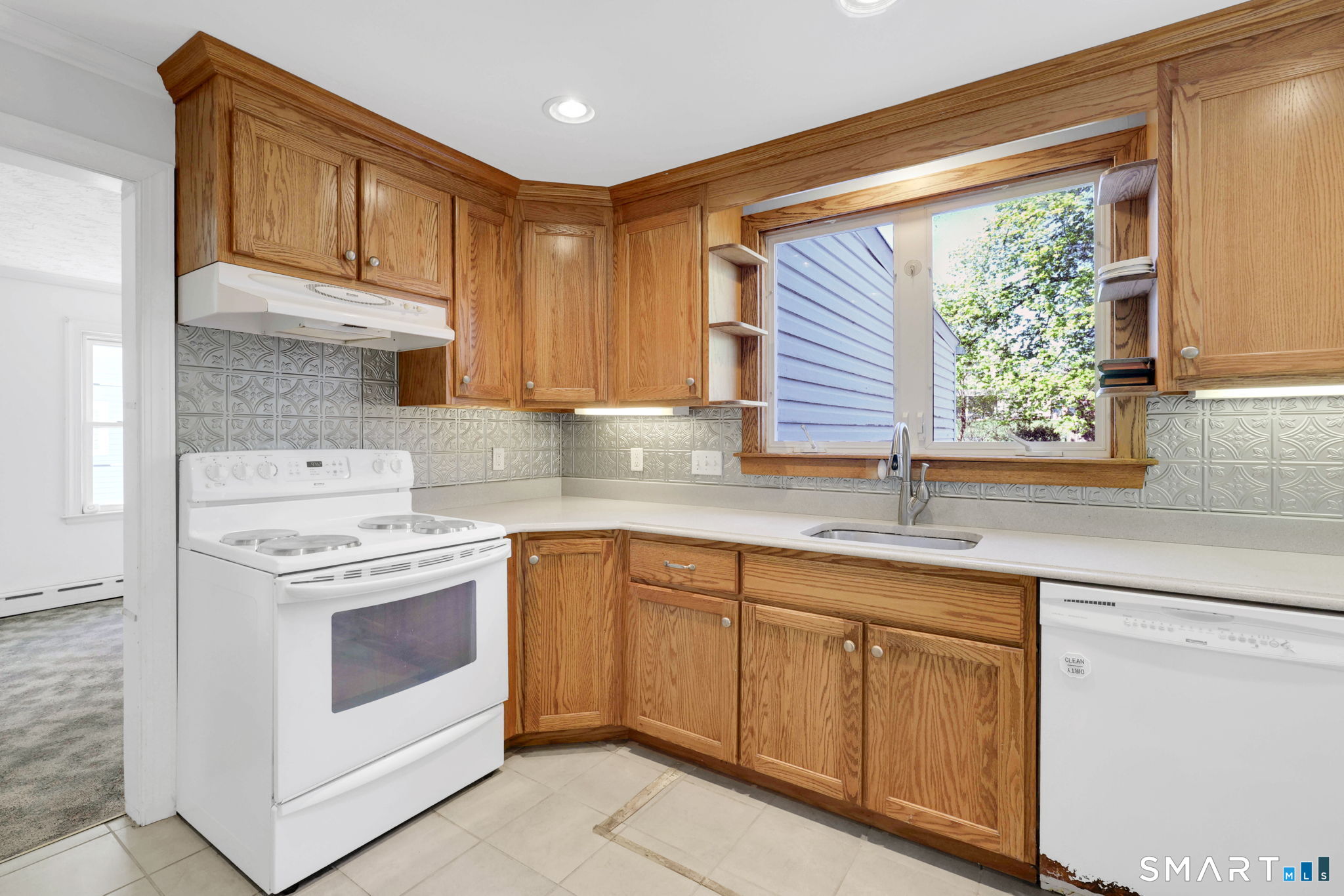 53 Alexander Street Manchester, CT 06040 - Photo 7 of 35 a kitchen with granite countertop white cabinets and white appliances